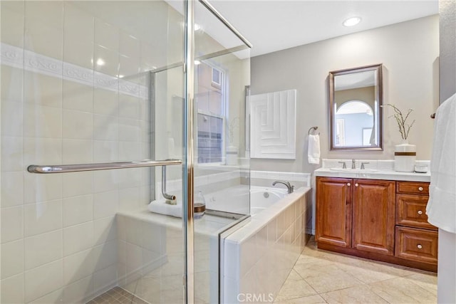 bathroom with tile patterned flooring, vanity, and shower with separate bathtub