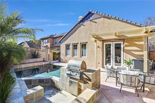 view of patio / terrace featuring french doors, outdoor lounge area, exterior kitchen, and grilling area