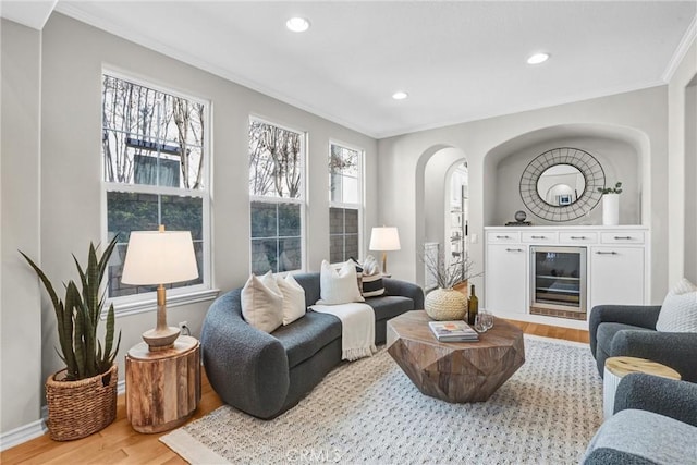 living room featuring hardwood / wood-style floors and crown molding