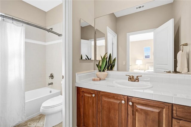 full bathroom with toilet, tile patterned floors, plenty of natural light, shower / bath combo, and vanity