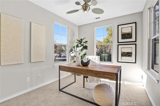 home office featuring ceiling fan and light carpet