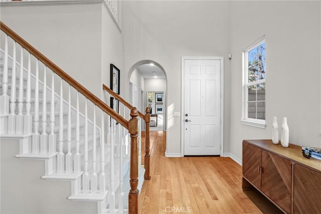 entryway featuring a high ceiling and light wood-type flooring