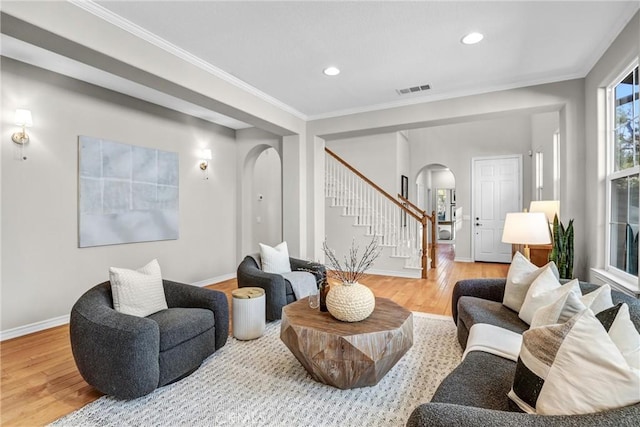 living room with hardwood / wood-style flooring and crown molding