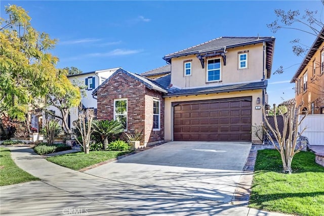 view of property featuring a front yard and a garage