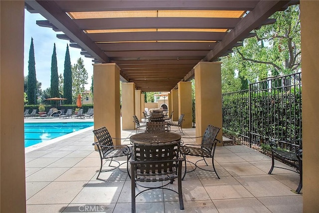 view of patio / terrace with a community pool and a pergola