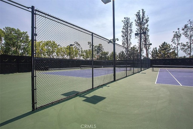 view of tennis court featuring basketball court