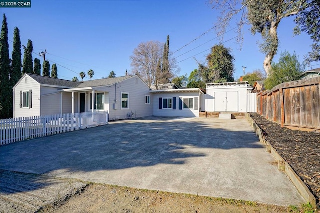 rear view of property with a storage shed