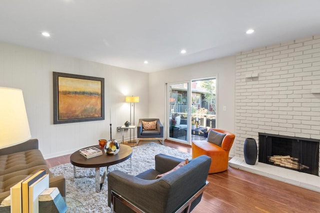 living room featuring dark hardwood / wood-style flooring and a fireplace