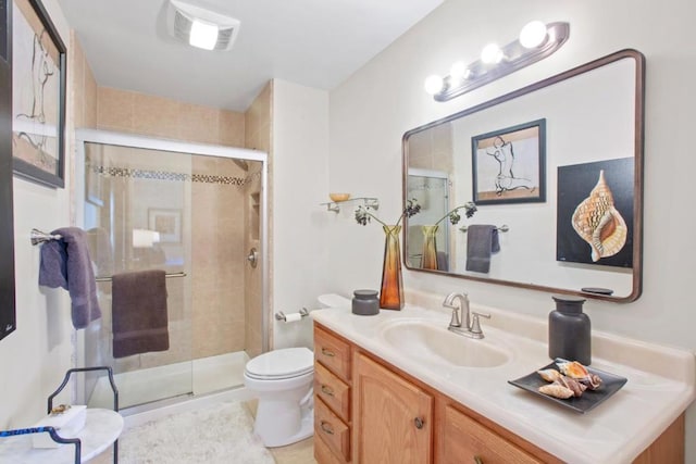 bathroom with toilet, tile patterned floors, walk in shower, and vanity