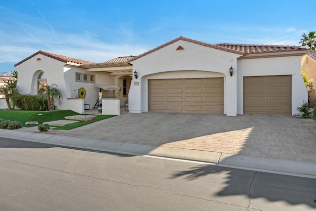 mediterranean / spanish-style home featuring a garage