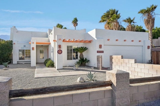 southwest-style home featuring a garage