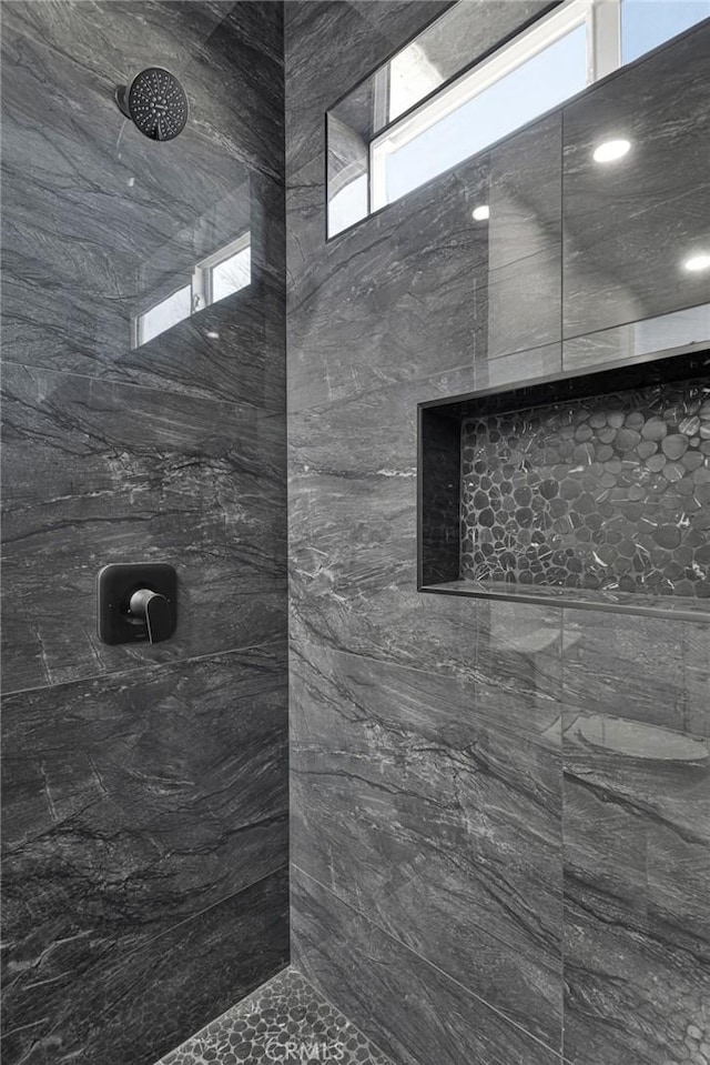 bathroom with a tile shower