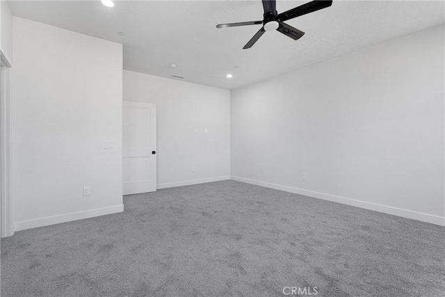 spare room featuring carpet and ceiling fan