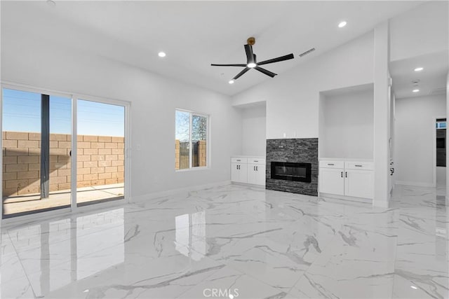 unfurnished living room with lofted ceiling, ceiling fan, and a fireplace