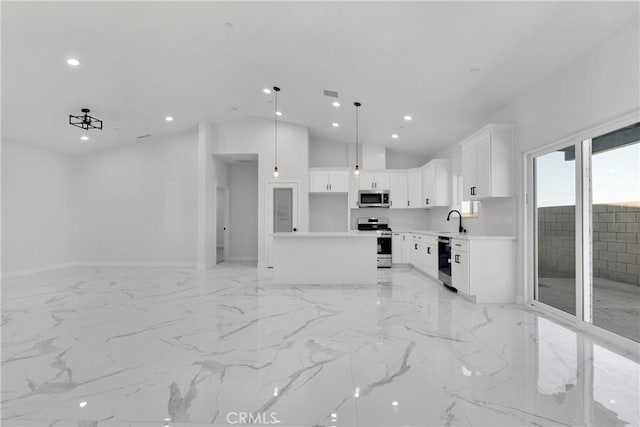 kitchen with white cabinetry, stainless steel appliances, a center island, hanging light fixtures, and sink