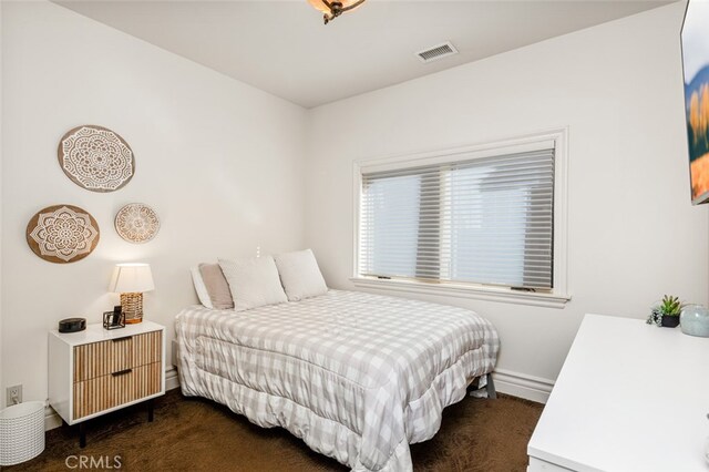 bedroom with dark colored carpet