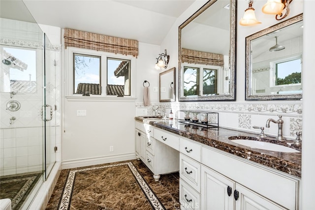 bathroom featuring a shower with shower door, backsplash, and vanity