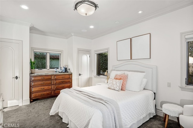 bedroom featuring dark colored carpet, ornamental molding, and multiple windows