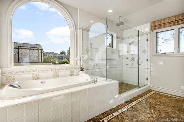 bathroom featuring shower with separate bathtub