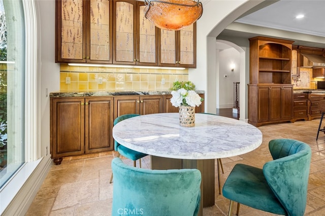 dining space with crown molding