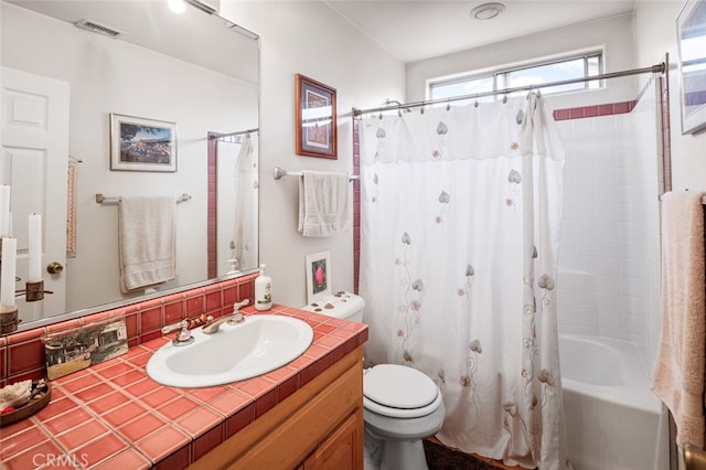 full bathroom with toilet, vanity, and shower / tub combo