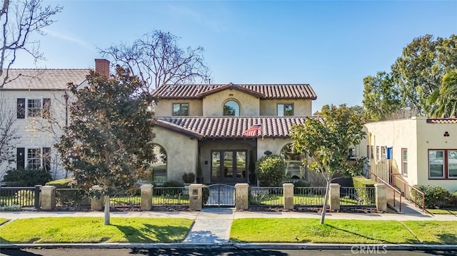 mediterranean / spanish-style home featuring a front yard