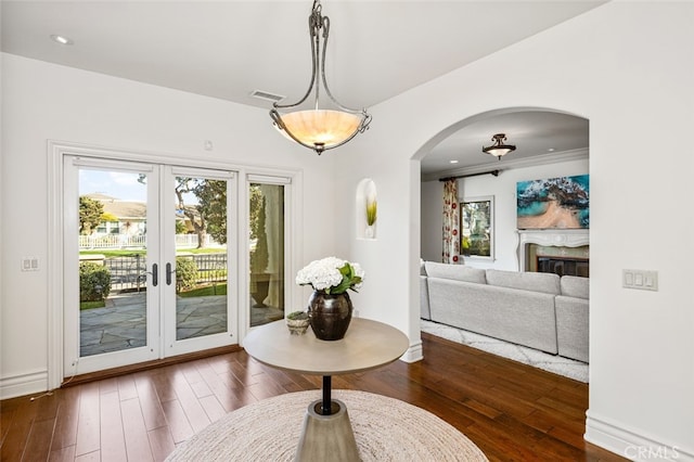 dining area with dark hardwood / wood-style flooring and french doors