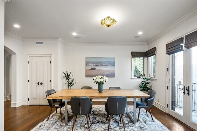 dining room featuring ornamental molding, dark hardwood / wood-style flooring, and french doors