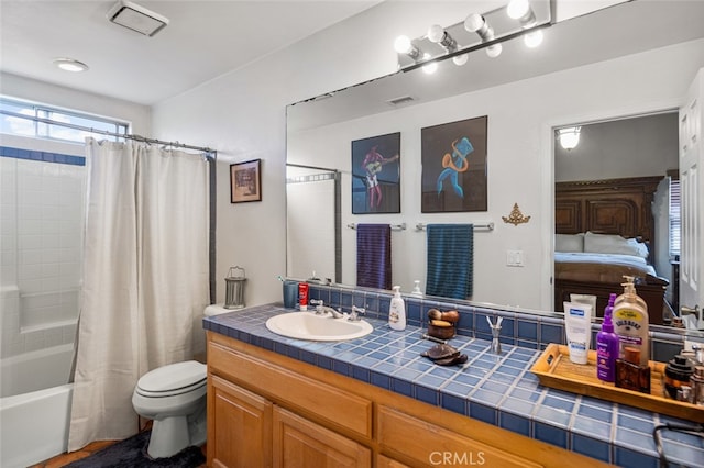 full bathroom featuring toilet, vanity, and shower / bath combo with shower curtain