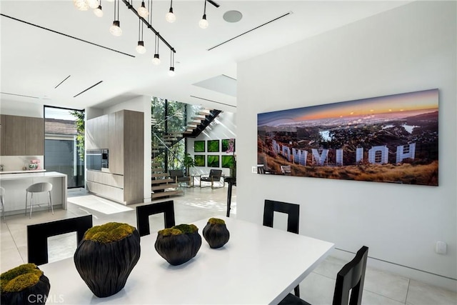 dining room with expansive windows and light tile patterned floors