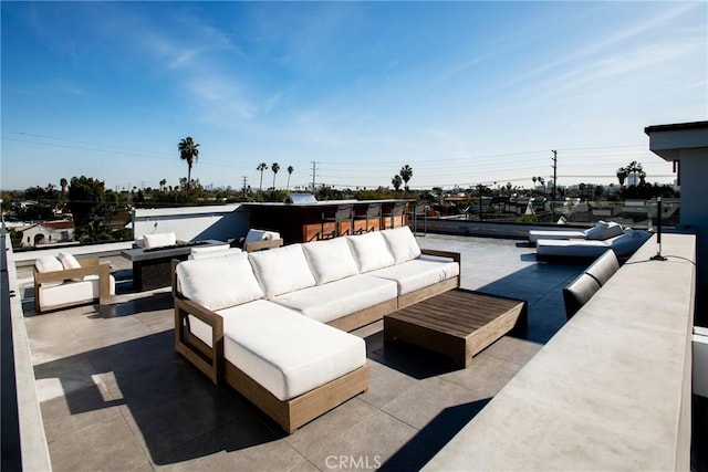 view of patio featuring a bar and an outdoor hangout area