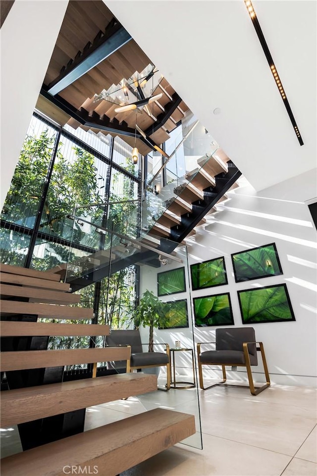 stairway with tile patterned flooring