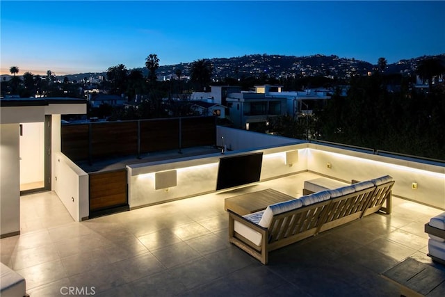 patio terrace at dusk with an outdoor kitchen