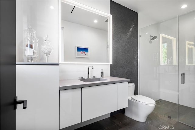 bathroom with toilet, vanity, and walk in shower