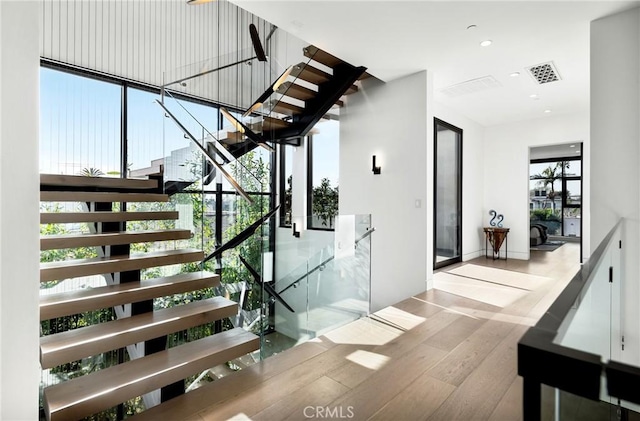 staircase with hardwood / wood-style floors