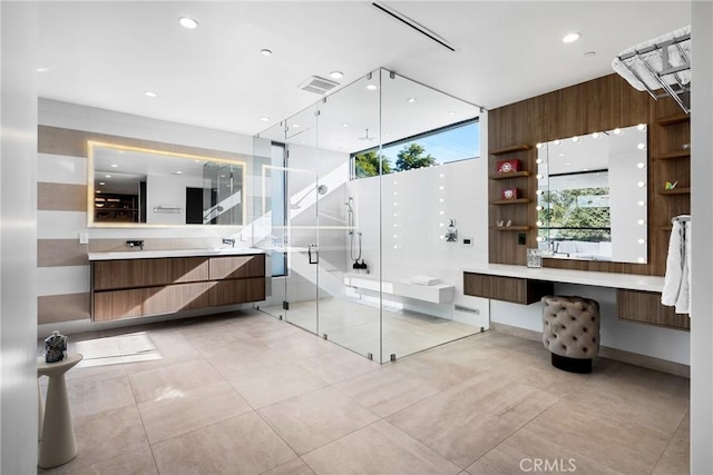 bathroom featuring a shower with shower door, vanity, and tile patterned floors