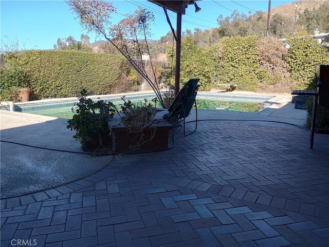 view of patio with a fenced in pool