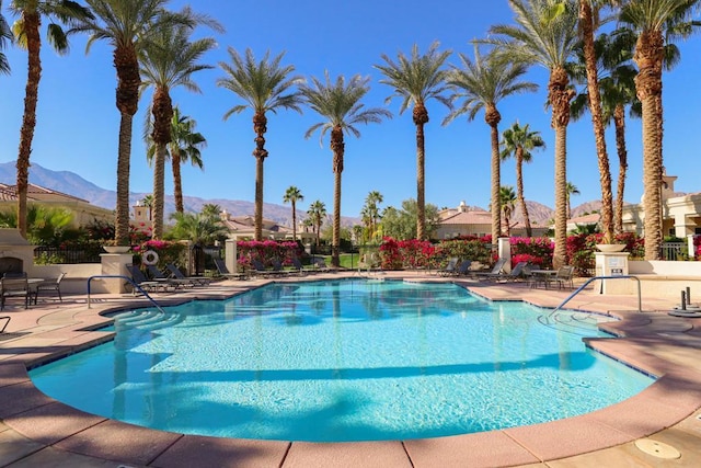 view of pool with a mountain view and a patio area