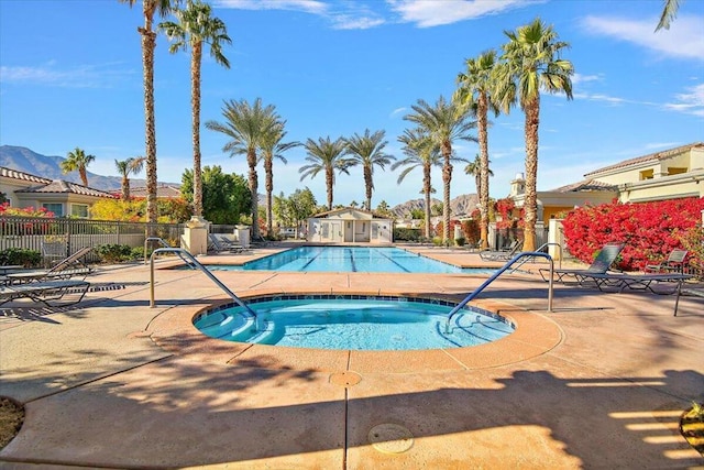 view of pool featuring a hot tub and a patio