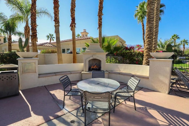 view of patio with exterior fireplace