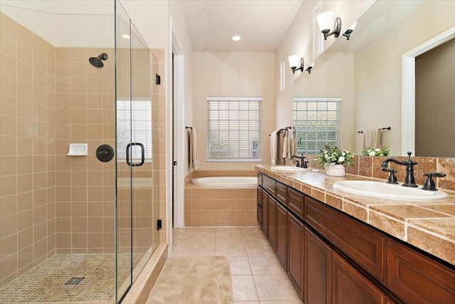 bathroom with tile patterned floors, vanity, and independent shower and bath