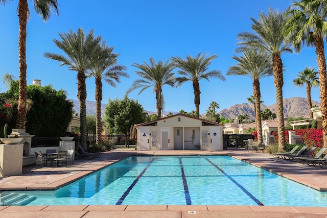 view of pool with a mountain view and a patio