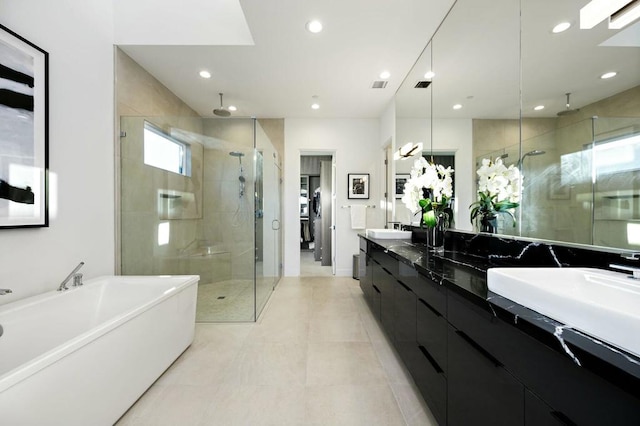 bathroom featuring vanity and separate shower and tub