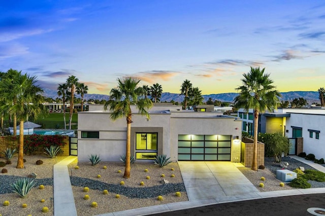 modern home featuring a garage and a mountain view