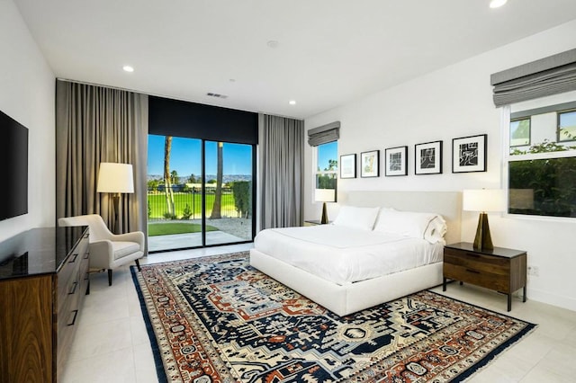 bedroom featuring multiple windows and access to outside