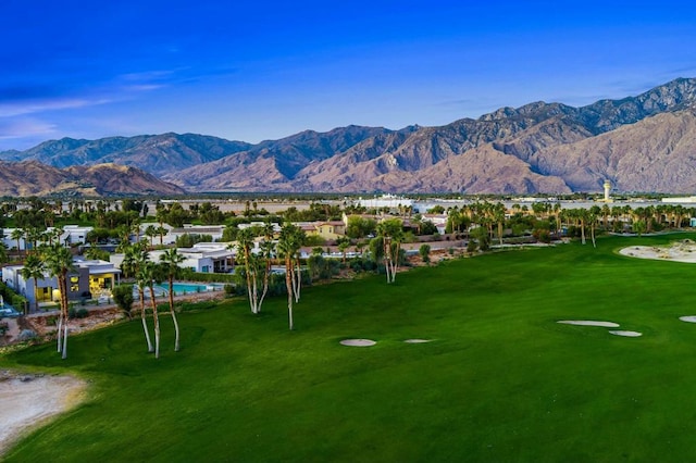 view of home's community with a mountain view and a yard