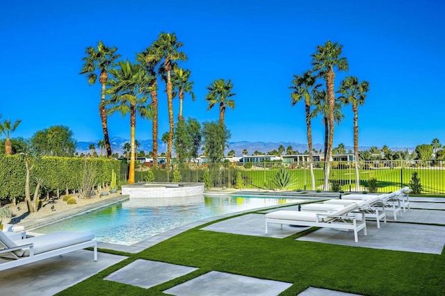 view of swimming pool with an in ground hot tub, a yard, a mountain view, and a patio area