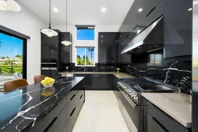 kitchen featuring light tile patterned flooring, decorative light fixtures, ventilation hood, high end stainless steel range oven, and backsplash