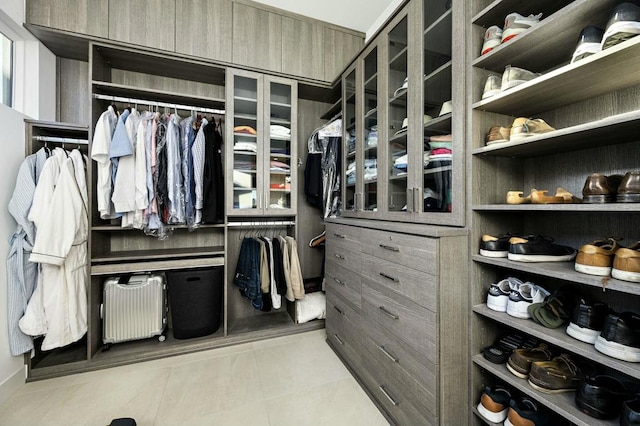 spacious closet featuring radiator and light tile patterned floors