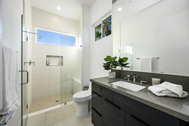 bathroom with backsplash, vanity, an enclosed shower, toilet, and tile patterned floors